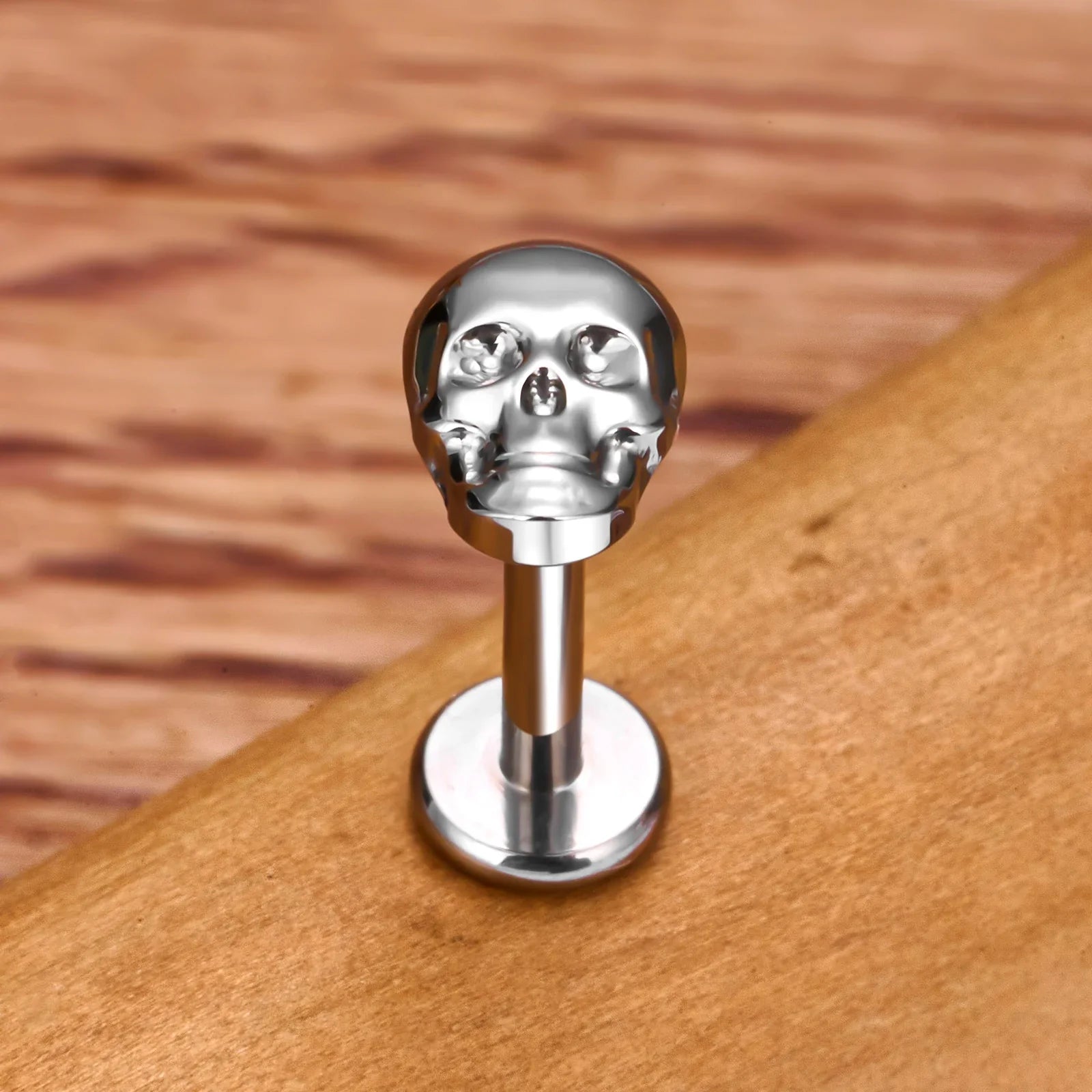 Skull nose stud in gold and silver titanium ear stud